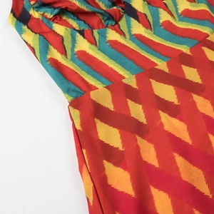 Close-up of vibrant multi-color geometric zigzag patterns on women summer dress fabric
