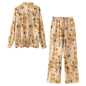 Flat lay of vintage floral long sleeve shirt and elastic waist trousers set in yellow print