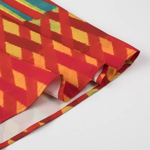 Detail of colorful geometric print hem on a stylish woven summer dress for women