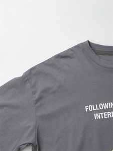 Detail of round neckline and white printed text on high-quality dark grey cotton T-shirt