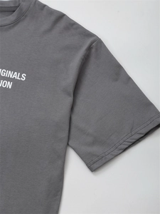 Detail of soft charcoal cotton t-shirt featuring white Originals graphic print and crew neck