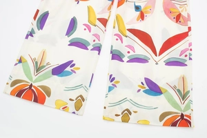Detailed view of wide-leg poplin trousers with abstract floral and geometric prints