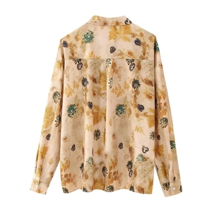 Relaxed long-sleeve women's shirt featuring autumn leaf prints on a white background