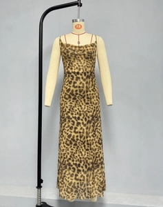 Detail of leopard print maxi dress with slim straps and draped neckline texture