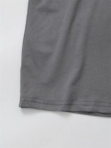 Detail view of the fine double-needle stitching on grey cotton t-shirt bottom hem