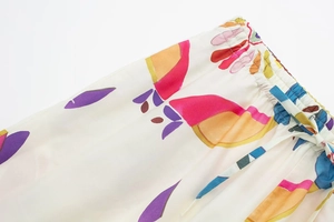 Detailed macro view of the elastic waistband with drawstring on colorful printed poplin pants