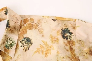 Detail shot of summer floral print shirt showing refined lapel design and smooth satin fabric