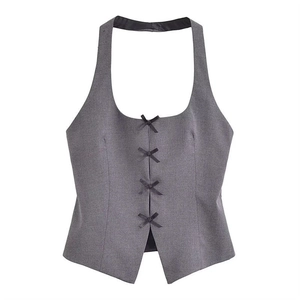 Détail du haut dos nu gris orné de nœuds papillon noirs avec une coupe ajustée élégante