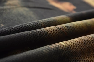 Detailed macro view of breathable mesh fabric with a woodland camouflage print pattern