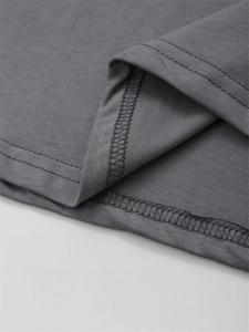 Detail of high-quality double-needle stitching and overlock seams on dark grey cotton T-shirt