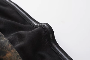 Detail of black mesh dress featuring non-slip silicone strip on interior fabric edge