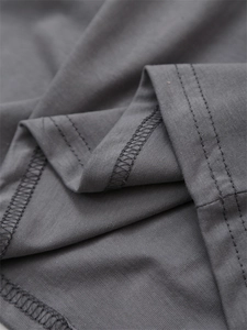 Close-up of the double-needle stitching and fabric texture on a dark grey knit t-shirt