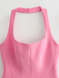 Detail of pink halter top with corset-style stitching and textured woven fabric