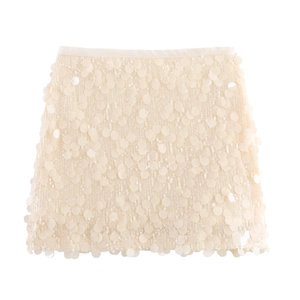 Detailed close-up of glossy cream sequins on a high-waisted chic mini A-line skirt
