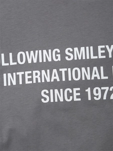 Detail of gray cotton knit fabric with Smiley International printed white lettering