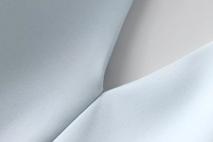 Macro detail of high-quality light blue fabric with precise stitching and fine texture