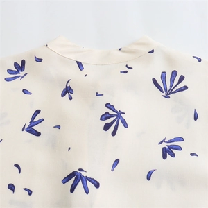 Close-up detail of the neckline on a French style floral print mini dress for women