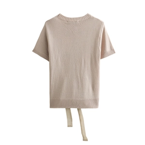 Short sleeve knit top in light beige featuring ribbed texture and stylish bow tie hem details