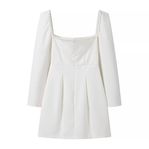Detail of square neckline with white pearl embellishments on a mini A-line dress