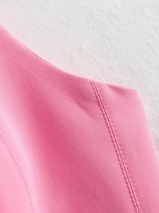 Close-up of high-quality double stitching on the pink slim-fit halter top fabric