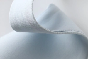 Macro detail of high-quality light blue knitted fabric texture and fine stitching work