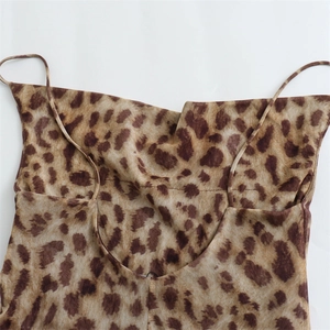 Detail of leopard print dress featuring a chic cowl neck and delicate spaghetti straps