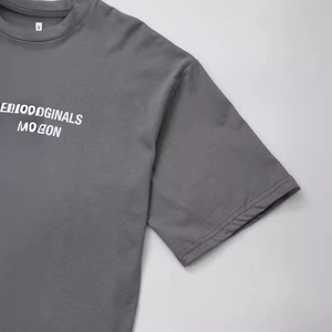 Dark grey crew neck T-shirt featuring white graphic letter print in a casual streetwear style