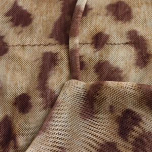 Close-up of leopard print breathable mesh fabric with sewing stitches and drawstring