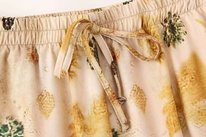 Detail of elastic waist with adjustable drawstring on floral printed summer trousers