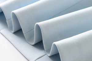 Macro shot of light blue sleeveless pleated dress fabric showing texture and pleats