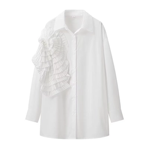 Detailed close-up of 3D floral ruffles on white long-sleeve shirt with classic collar