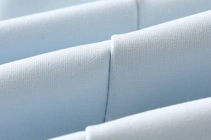 Close-up of light blue woven fabric with high-density texture for summer dresses