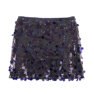Close-up of deep purple and blue sequins on a stylish mini skirt with satin trim