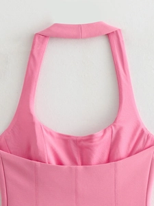 Detail of pink halter neck top showing corset style stitching and fabric texture