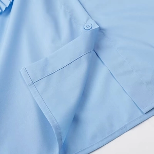 Close-up of stitching and blue button details on a summer cotton floral shirt