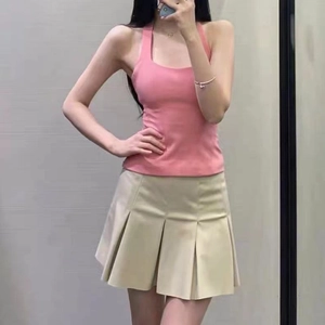 Pink halter top and beige pleated skirt summer outfit set shown on model in mirror
