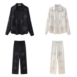 Detail of beaded floral embroidery on silk-texture long-sleeved shirt and pants set