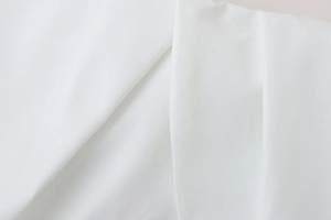 Detailed close-up showing the premium white poplin fabric texture and pleated finish on the top