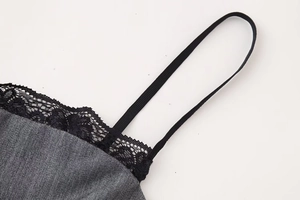 Detail of grey denim fabric camisole with black lace trim and elastic straps