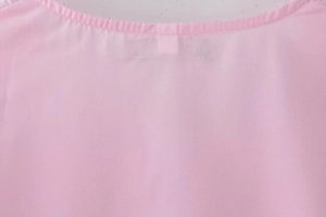 Close-up showing the neckline stitching and fabric texture of a pink casual shirt