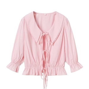 Detail of pink striped shirt featuring double Peter Pan collar and bow tie closures