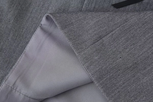Detail shot of grey satin fabric texture with clean stitching and smooth silk lining