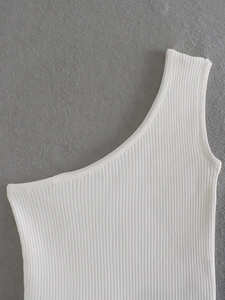 Detailed view of white rib-knit fabric and asymmetrical one-shoulder design