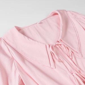 Detail shot of vintage pointed collar and lace-up neck on pink striped shirt