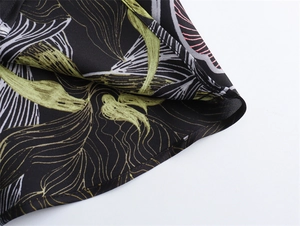Detailed view of the precise rolled hem stitching on the floral satin midi dress