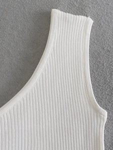 Close-up of white ribbed knit fabric texture and high-quality shoulder strap stitching