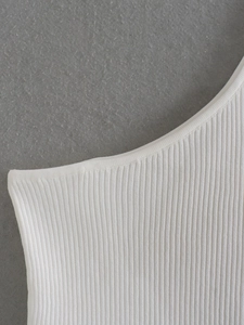 Close-up of white ribbed knit fabric texture and premium hem stitching detail