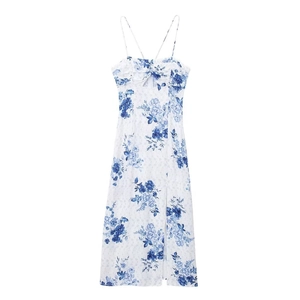 Close-up of floral summer dress with cutout detail, cross pleats and high side slit