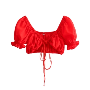 Detail of red flare sleeve top with front drawstring tie and square neckline texture