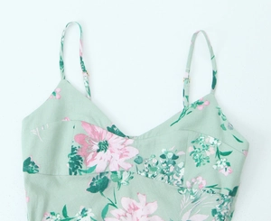 Detail of mint green floral midi dress with spaghetti straps and v-neckline